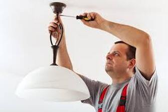 Electrician working on lighting